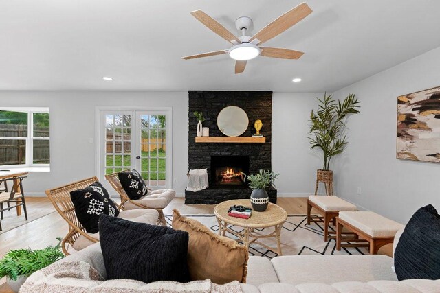 305 Pecan Ln, Round Rock, TX 78664 - living area featuring light wood finished floors, a fireplace, recessed lighting, and ceiling fan