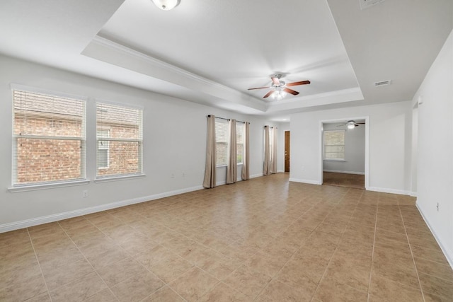 839 Salado Creek Ln, Georgetown, TX 78633 - spare room with a ceiling fan, a tray ceiling, visible vents, and baseboards