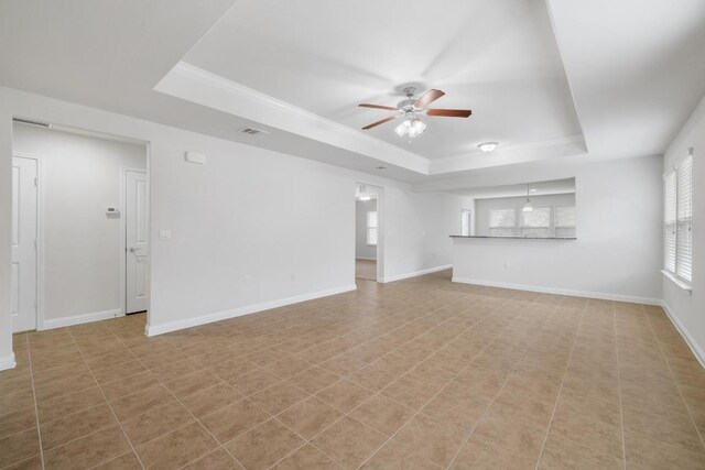 839 Salado Creek Ln, Georgetown, TX 78633 - unfurnished living room with a ceiling fan, baseboards, visible vents, and a raised ceiling