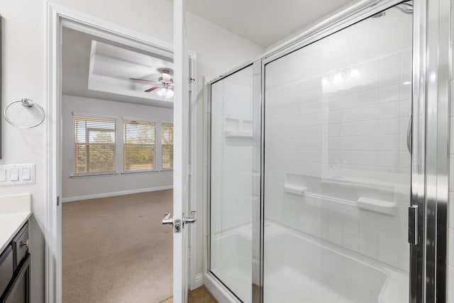 839 Salado Creek Ln, Georgetown, TX 78633 - bathroom with vanity, baseboards, an enclosed shower, a tray ceiling, and a ceiling fan