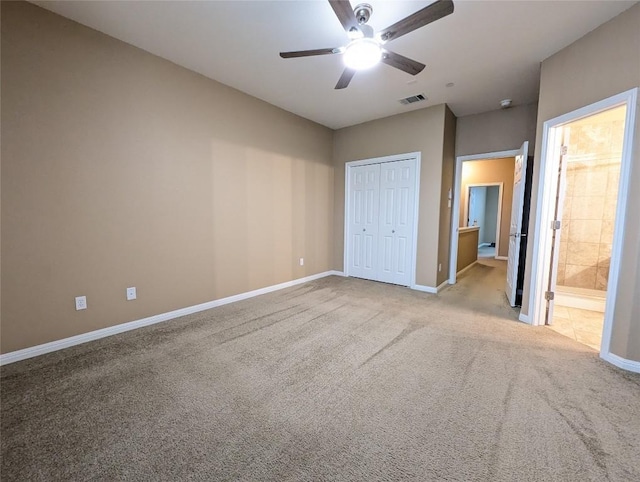 unfurnished bedroom with a closet, visible vents, baseboards, and carpet floors