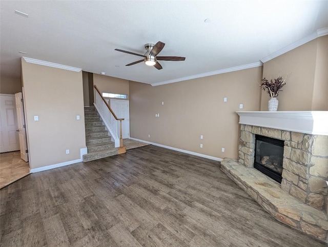 unfurnished living room featuring a fireplace, baseboards, a ceiling fan, and wood finished floors