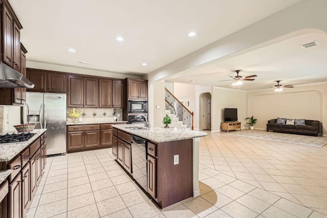 2920 Agave Loop, Round Rock, TX 78681 - kitchen with appliances with stainless steel finishes, arched walkways, light tile patterned floors, tasteful backsplash, and recessed lighting