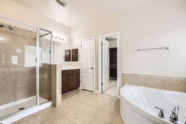 2920 Agave Loop, Round Rock, TX 78681 - bathroom with a stall shower, a bath, vanity, and tile patterned floors