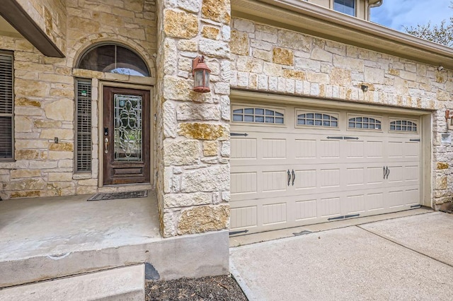 2920 Agave Loop, Round Rock, TX 78681 - view of exterior entry with stone siding, a garage, and driveway