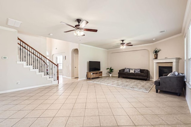 2920 Agave Loop, Round Rock, TX 78681 - living area featuring arched walkways, a ceiling fan, stairway, a fireplace, and light tile patterned floors