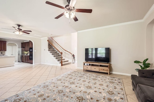 2920 Agave Loop, Round Rock, TX 78681 - living area featuring arched walkways, a ceiling fan, light tile patterned floors, stairway, and crown molding