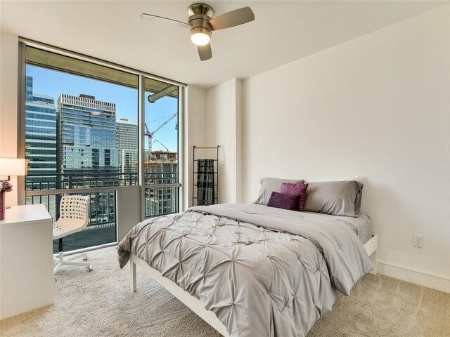 222 W Ave Unit 1907, Austin, TX 78701 - bedroom featuring a wall of windows, carpet, a city view, and ceiling fan
