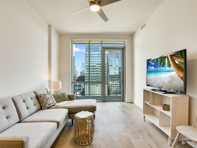 222 W Ave Unit 1907, Austin, TX 78701 - living room with ceiling fan and light wood-style floors