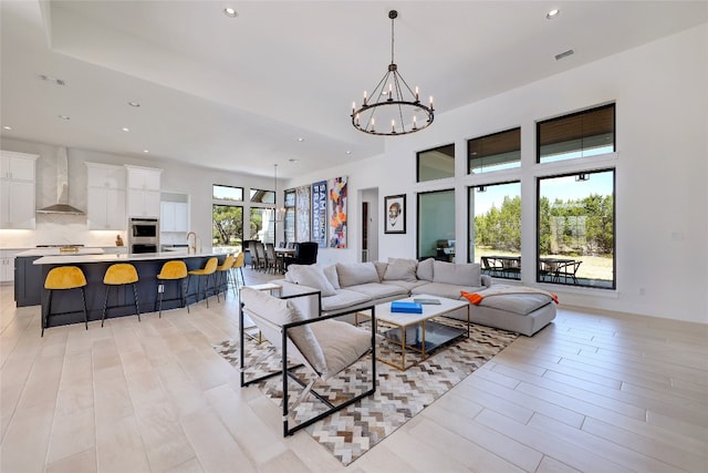 living area with recessed lighting, a chandelier, and visible vents