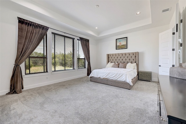 bedroom featuring carpet flooring, visible vents, baseboards, recessed lighting, and a raised ceiling