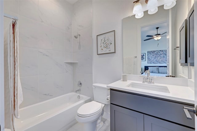 ensuite bathroom featuring ensuite bathroom, toilet, vanity, a ceiling fan, and shower / bathing tub combination