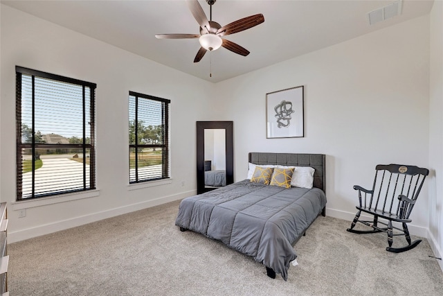 bedroom with baseboards, visible vents, carpet floors, and a ceiling fan