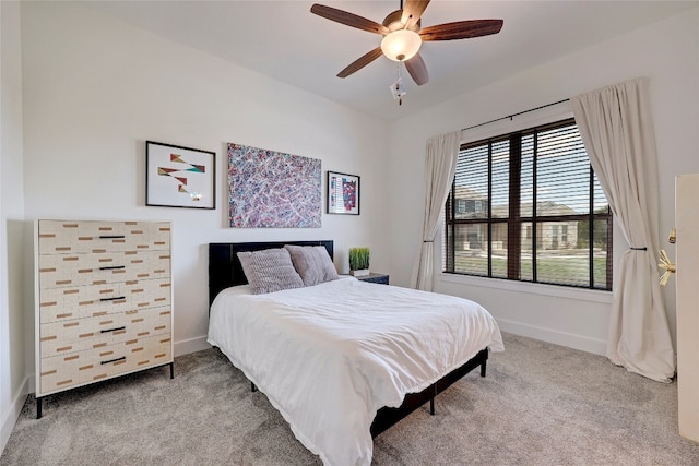 carpeted bedroom featuring baseboards and ceiling fan