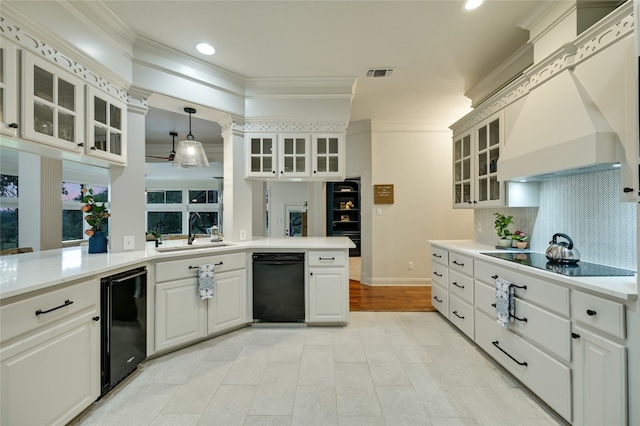 1174 Royal Eagle Dr, Fischer, TX 78623 - kitchen with a sink, black appliances, ornamental molding, premium range hood, and light countertops