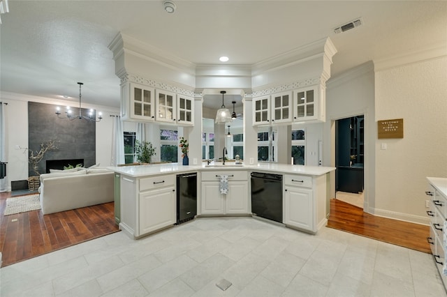 1174 Royal Eagle Dr, Fischer, TX 78623 - kitchen with black dishwasher, a chandelier, light countertops, open floor plan, and crown molding