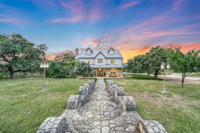 1174 Royal Eagle Dr, Fischer, TX 78623 - view of front of property featuring covered porch, a yard, a chimney, and stone siding