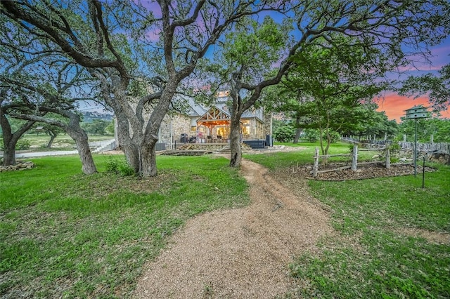 1174 Royal Eagle Dr, Fischer, TX 78623 - yard at dusk featuring a lawn