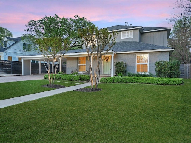 2517 Exposition Blvd, Austin, TX 78703 - traditional home featuring concrete driveway, an attached carport, board and batten siding, and brick siding