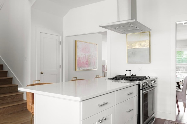 2517 Exposition Blvd, Austin, TX 78703 - kitchen with wall chimney exhaust hood, stainless steel gas range oven, light countertops, white cabinetry, and dark wood finished floors