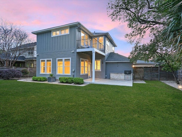 2517 Exposition Blvd, Austin, TX 78703 - back of property at dusk with a balcony, board and batten siding, and a patio