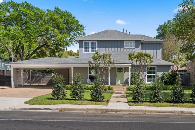 2517 Exposition Blvd, Austin, TX 78703 - traditional-style home featuring concrete driveway, an attached carport, a porch, board and batten siding, and roof with shingles