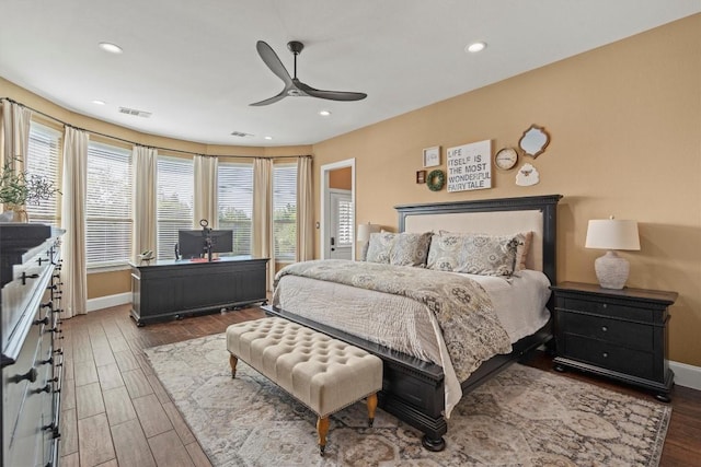 bedroom with wood finished floors, baseboards, and visible vents