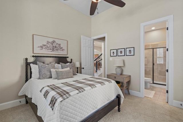 bedroom featuring tile patterned flooring, carpet, baseboards, and connected bathroom