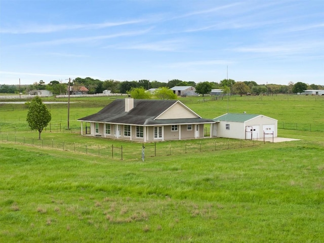 1234 County Road 135, Lincoln, TX 78948 - back of property featuring a chimney and a detached garage