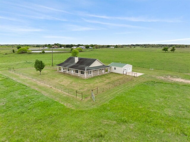 birds eye view of property with a rural view