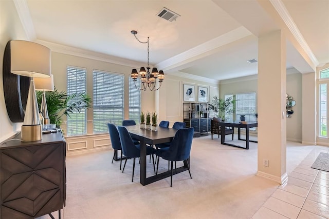dining space with a notable chandelier, a decorative wall, light colored carpet, visible vents, and ornamental molding