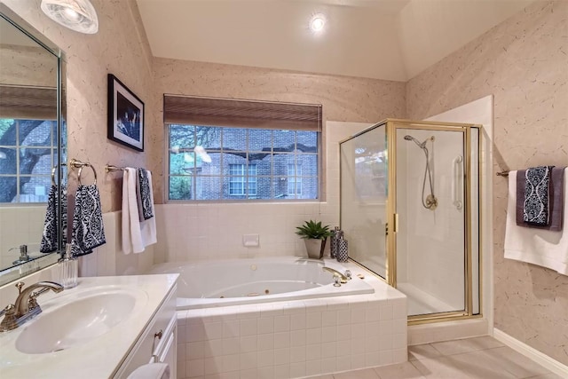bathroom with a stall shower, a whirlpool tub, a textured wall, and vanity