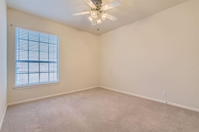 empty room with baseboards, carpet floors, and a ceiling fan