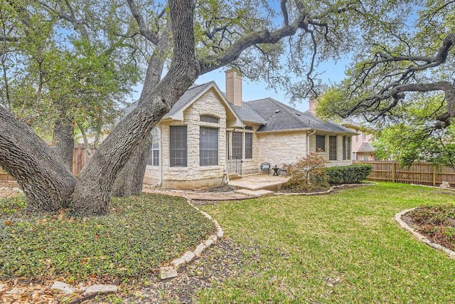 11100 Comiso Pala Path, Austin, TX 78726 - back of property with stone siding, a chimney, and roof with shingles