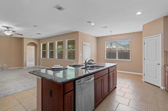 17920 Silent Harbor Loop, Pflugerville, TX 78660 - kitchen featuring stainless steel dishwasher, a sink, baseboards, arched walkways, and a ceiling fan