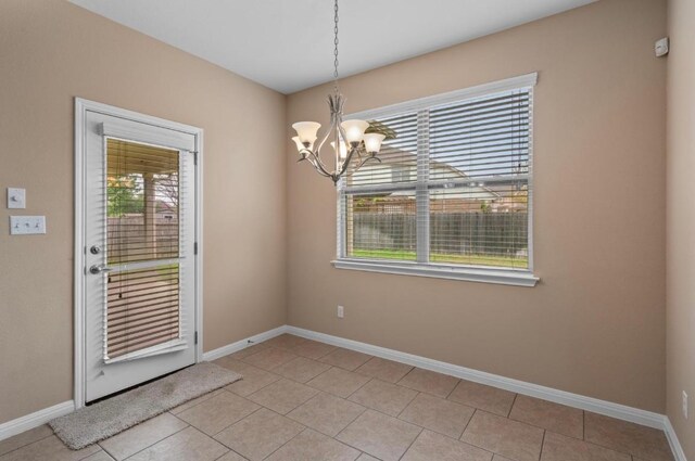 17920 Silent Harbor Loop, Pflugerville, TX 78660 - unfurnished dining area with a chandelier, baseboards, and light tile patterned floors