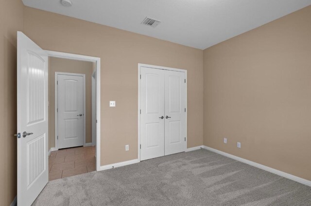 17920 Silent Harbor Loop, Pflugerville, TX 78660 - unfurnished bedroom featuring carpet flooring, baseboards, a closet, and tile patterned flooring