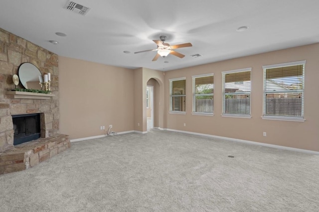 17920 Silent Harbor Loop, Pflugerville, TX 78660 - unfurnished living room featuring arched walkways, a ceiling fan, carpet floors, and plenty of natural light