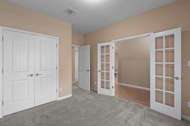 17920 Silent Harbor Loop, Pflugerville, TX 78660 - unfurnished bedroom featuring french doors, carpet flooring, a closet, and baseboards