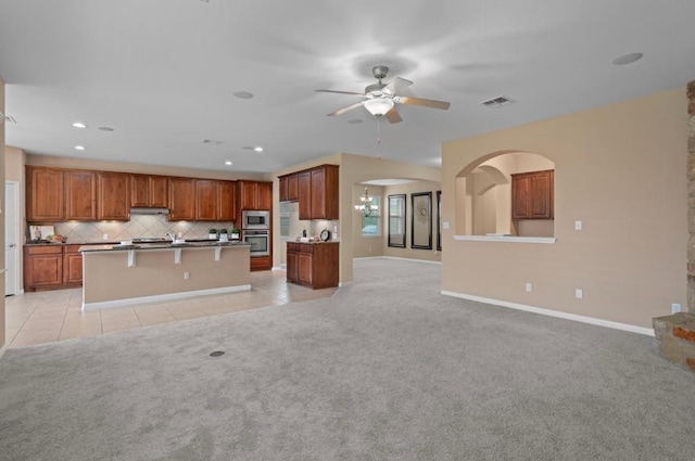 17920 Silent Harbor Loop, Pflugerville, TX 78660 - kitchen featuring open floor plan, a ceiling fan, light colored carpet, decorative backsplash, and light tile patterned floors