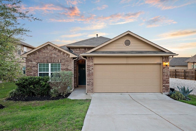 6608 May Shower Dr, Austin, TX 78744 - view of front of house with concrete driveway, a garage, and brick siding