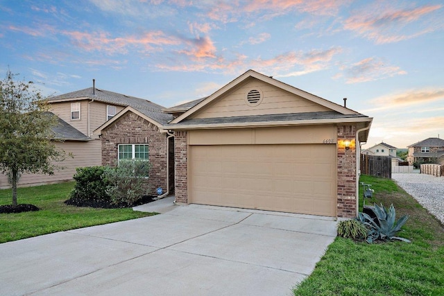 6608 May Shower Dr, Austin, TX 78744 - view of front facade featuring concrete driveway, a garage, and brick siding