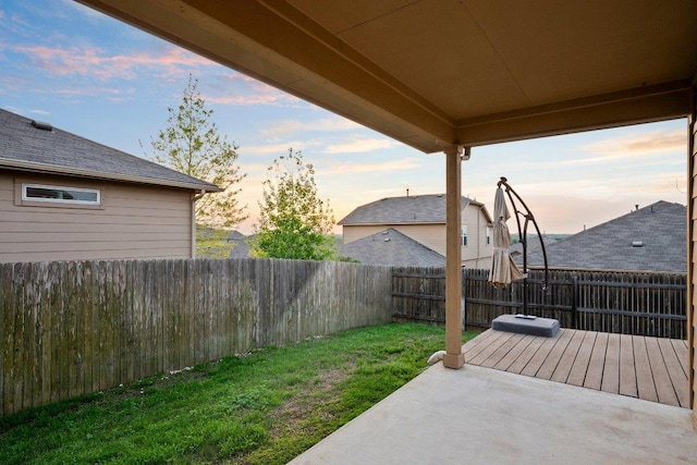 yard at dusk with a fenced backyard