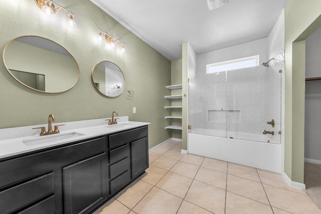 bathroom featuring tile patterned floors, a sink, double vanity, and bathtub / shower combination