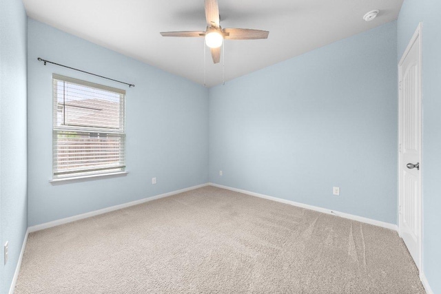 unfurnished room featuring carpet floors, baseboards, and ceiling fan