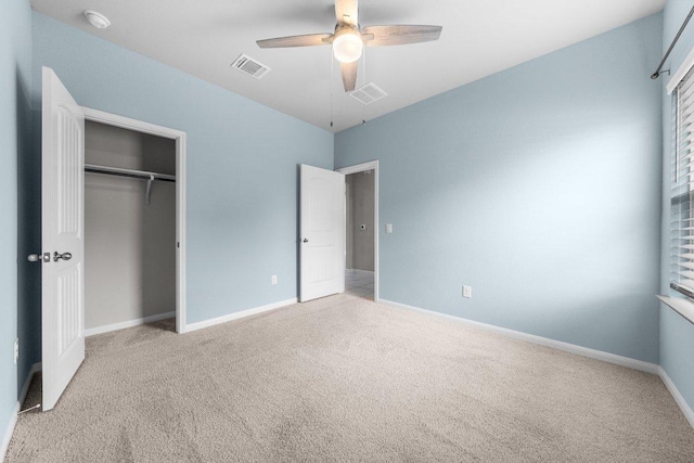 unfurnished bedroom featuring a closet, carpet flooring, baseboards, visible vents, and ceiling fan