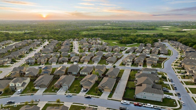 aerial view at dusk featuring a residential view