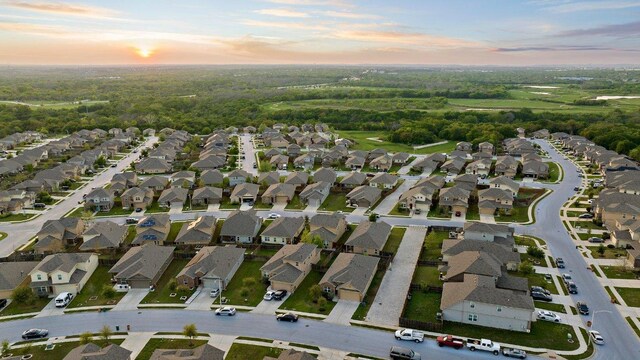 6608 May Shower Dr, Austin, TX 78744 - aerial view at dusk of a residential view and a view of trees