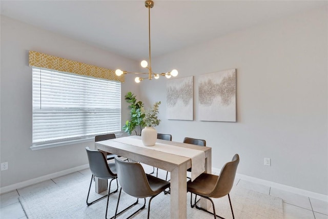 dining space featuring light tile patterned flooring, baseboards, and a chandelier