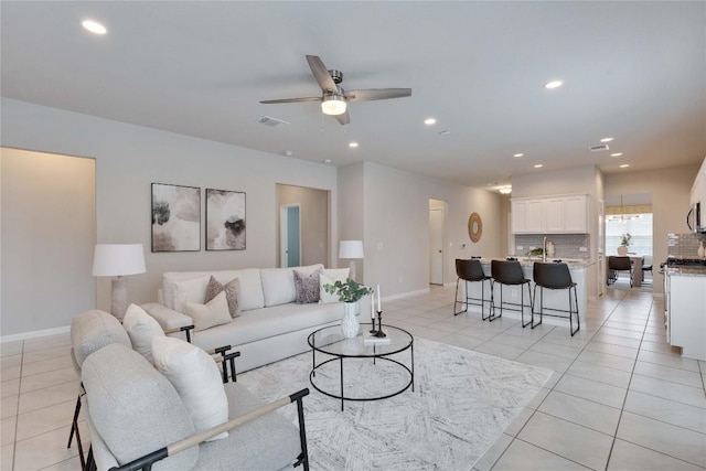 6608 May Shower Dr, Austin, TX 78744 - living area featuring a ceiling fan, recessed lighting, light tile patterned flooring, and baseboards